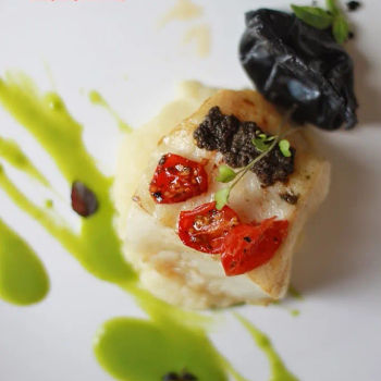 Pan Seared Cod Fish with Tapenade, Prawn and Scallop Ravioli, Potato Cream, Roma Tomato Confit and Herbs Emulsion