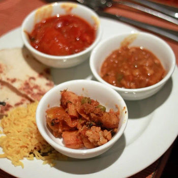 Clockwise- Tamatar Ka Kut (Fresh Tomatoes with Curry Leaves, Mustard and Tamarind-hyderabadi specialty), Sambhar (South Indian lentil preparation) and Aloo Gobi Matar (Potatoes, Cauliflowers and Green Peas, stir fried with Onions and Tomatoes).