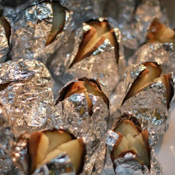 Baked Potatoes served with Scallions, Sour Cream and Beef Bacon Bits