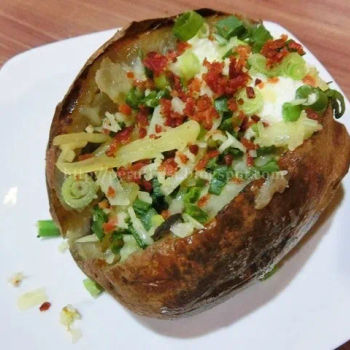 Baked potato topped with sour cream, cheese & bacon bits