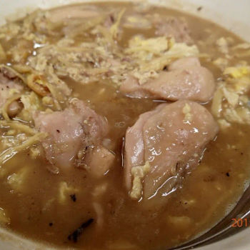 Chinese wine soup with chicken, fried egg and ginger stripes