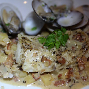 Baked Atlantic Cod with a Clam Chowder reduction and topped with bacon bits