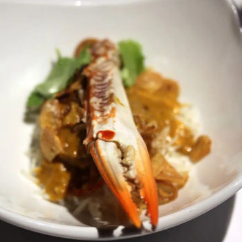 Coal Baked Crab Claws With Keralan curry sauce, cucumber and tomato salad