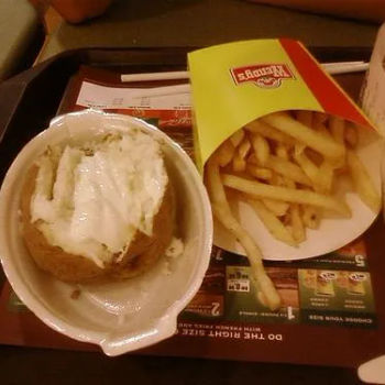 Baked potato in sour cream and fries
