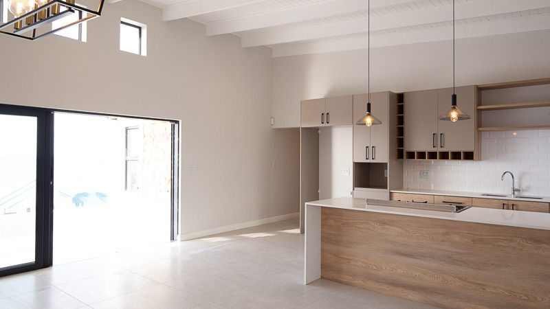 Unedited photo of a kitchen overlooking the ocean, with details outside the window lost due to limited dynamic range.
