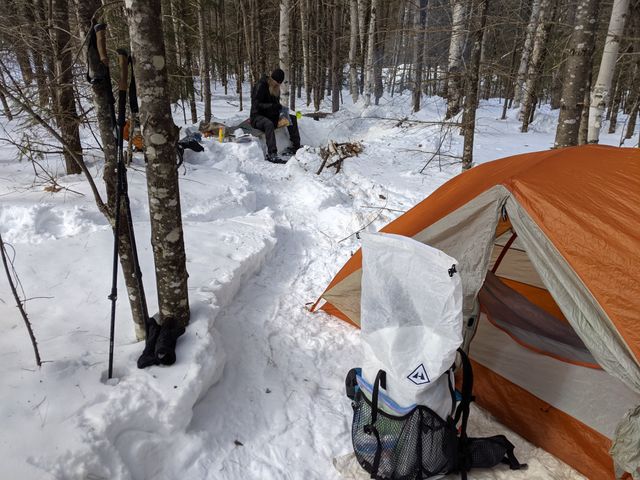 Tent and backpack at winter campsite