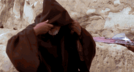 an old man taking off his hoodie