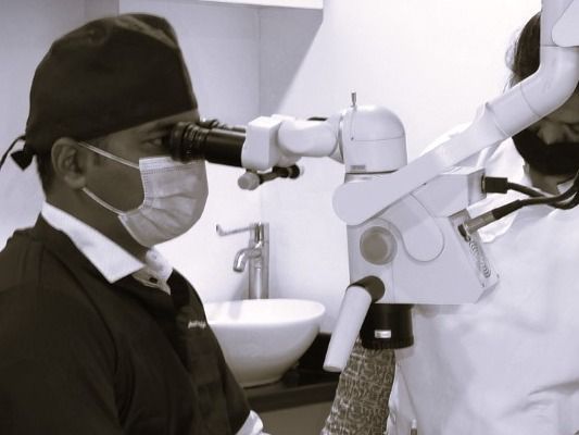 dr-bhushan-mahajan-dental-microscope-prudentia-micro-dental-care-Pune tablet