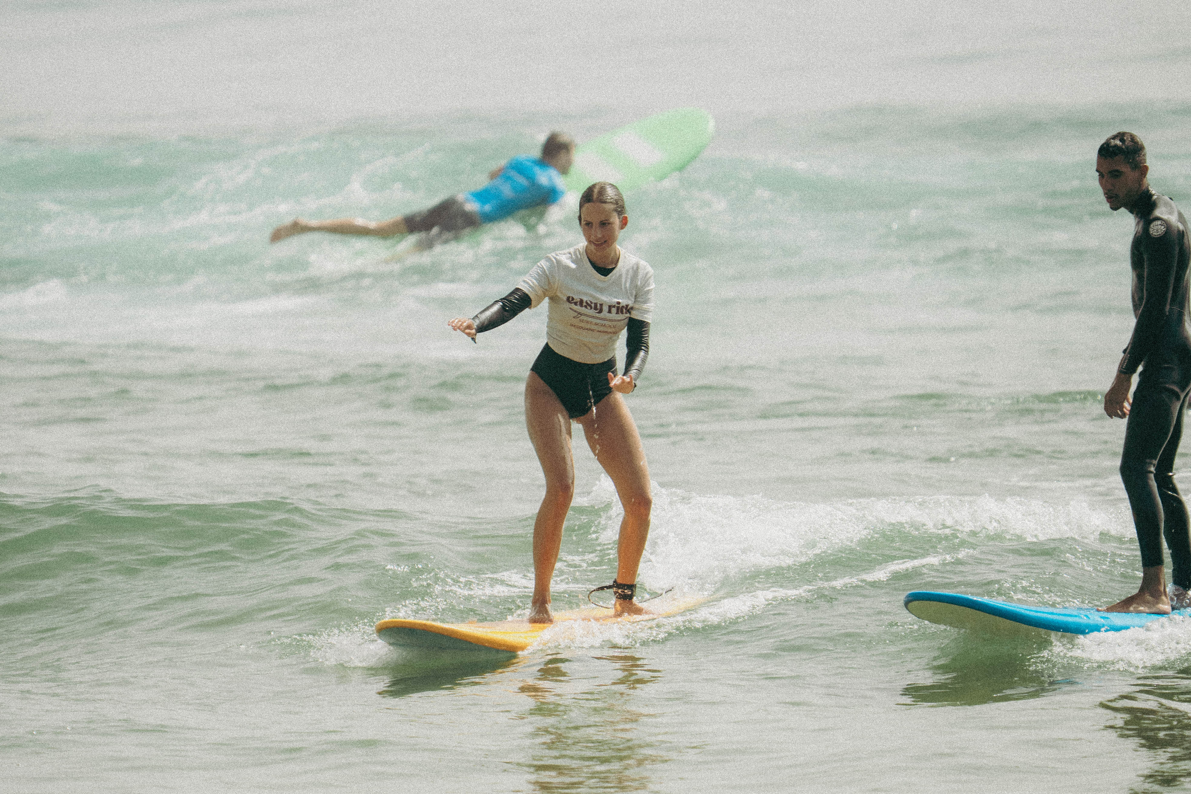 Surfer carrying a board on a Moroccan beach