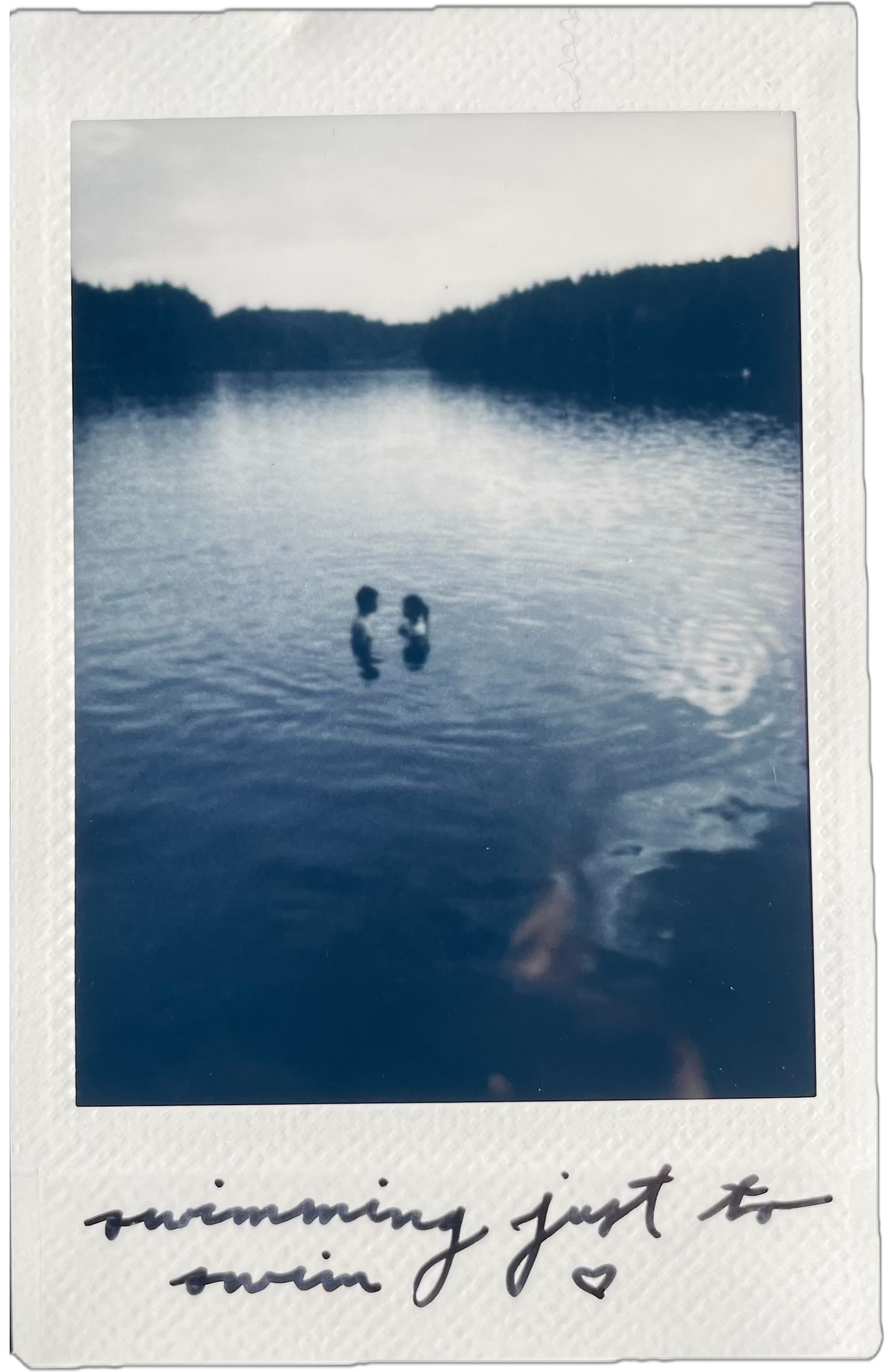 polaroid of two people in the middle of a lake