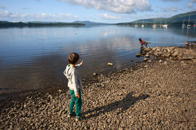 Youthful exuberance meets serene lakeside scenery in this playful and harmonious composition capturing the joy of outdoor activities.