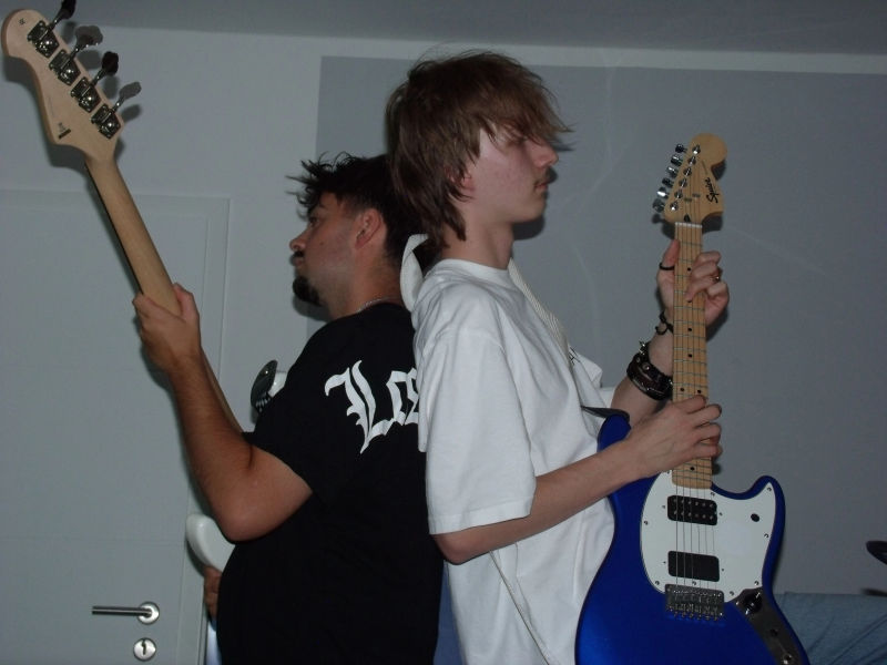 Neural Override and Ceddo standing back to back with their instruments