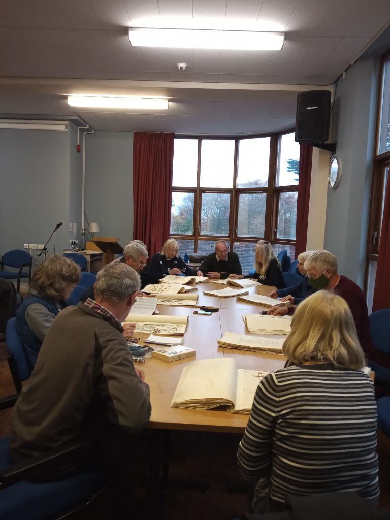 Members examining herbarium specimens