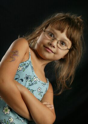 A child wears glasses that she has received from a Calgary Optical store.