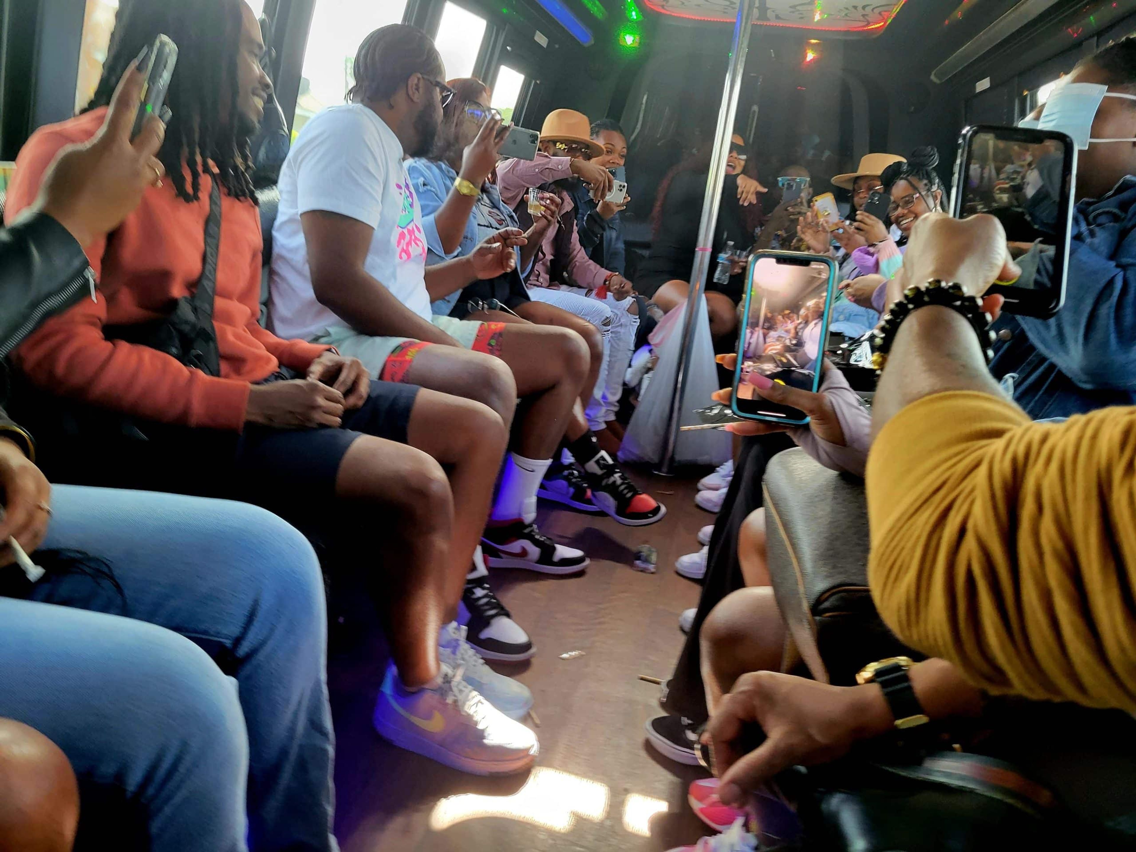 Group of people enjoying a lively atmosphere inside a bus.