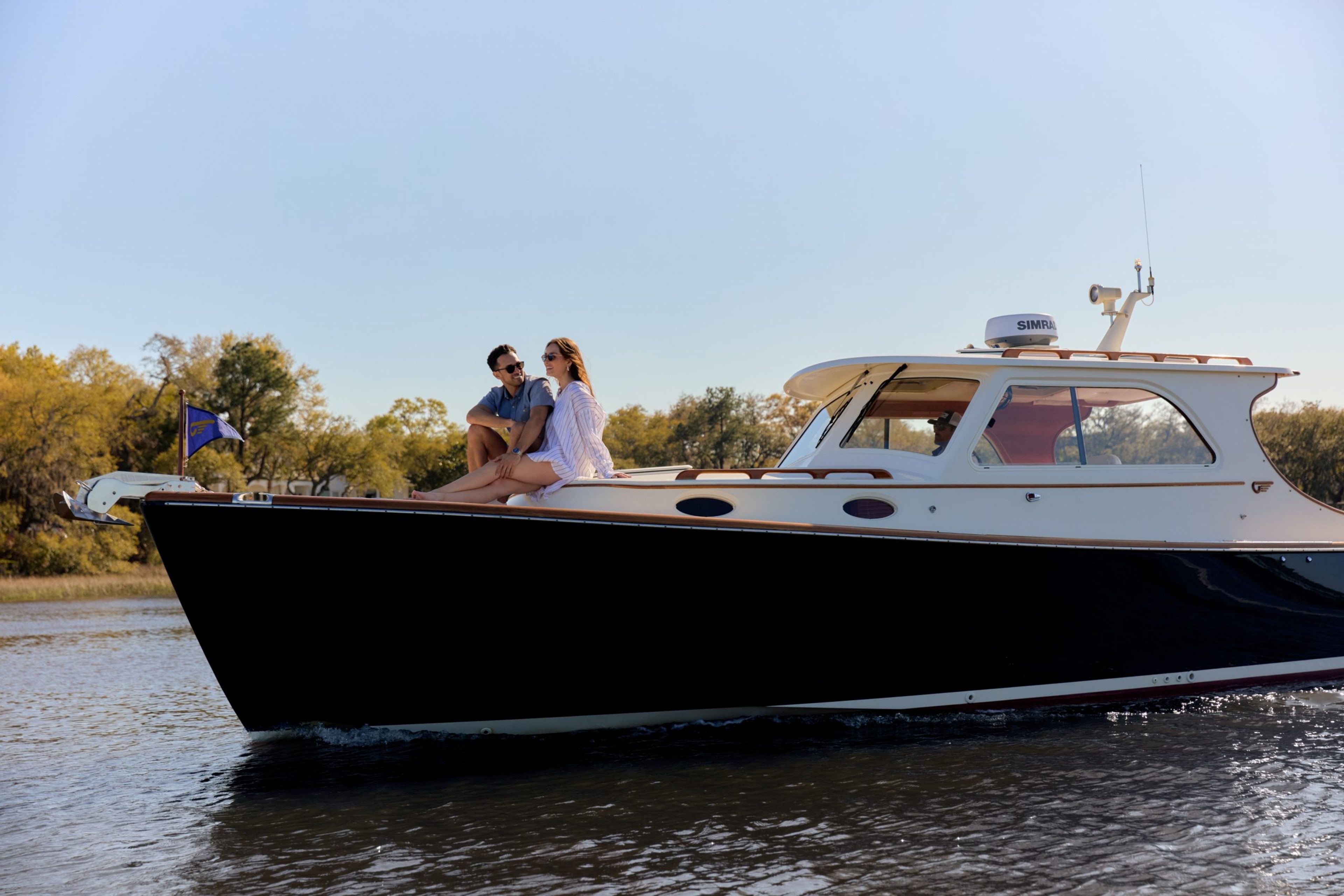 A couple enjoying a boat ride on a sunny day.