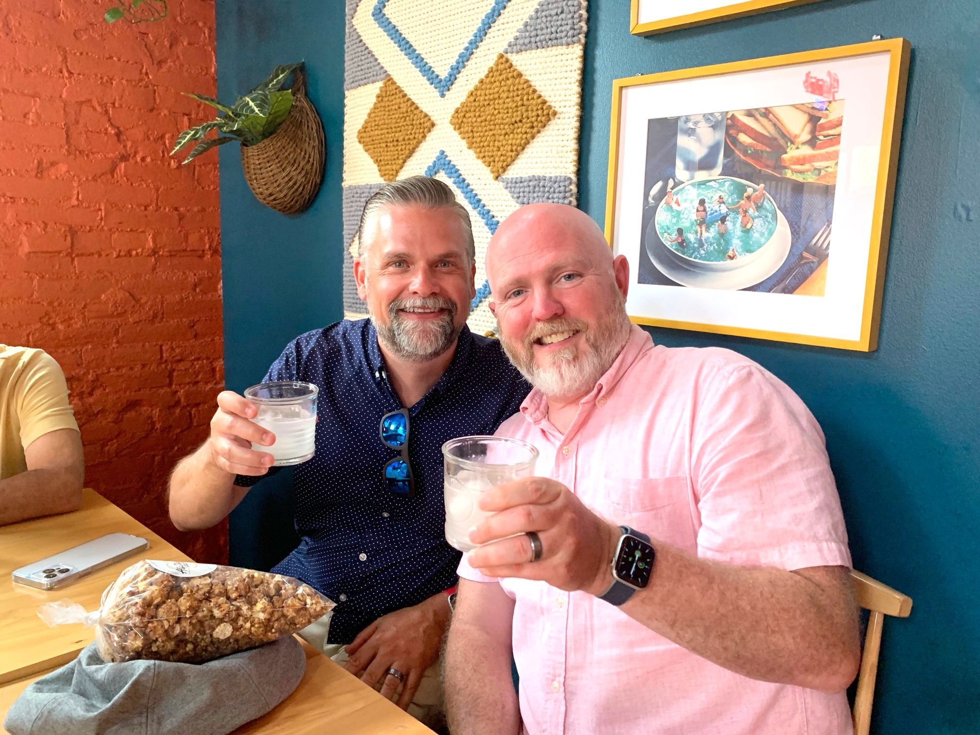 Two men smiling and enjoying each other's company on the Riverside Food Tours in Cincinnati Ohio: Over-the-Rhine Cocktail Tour