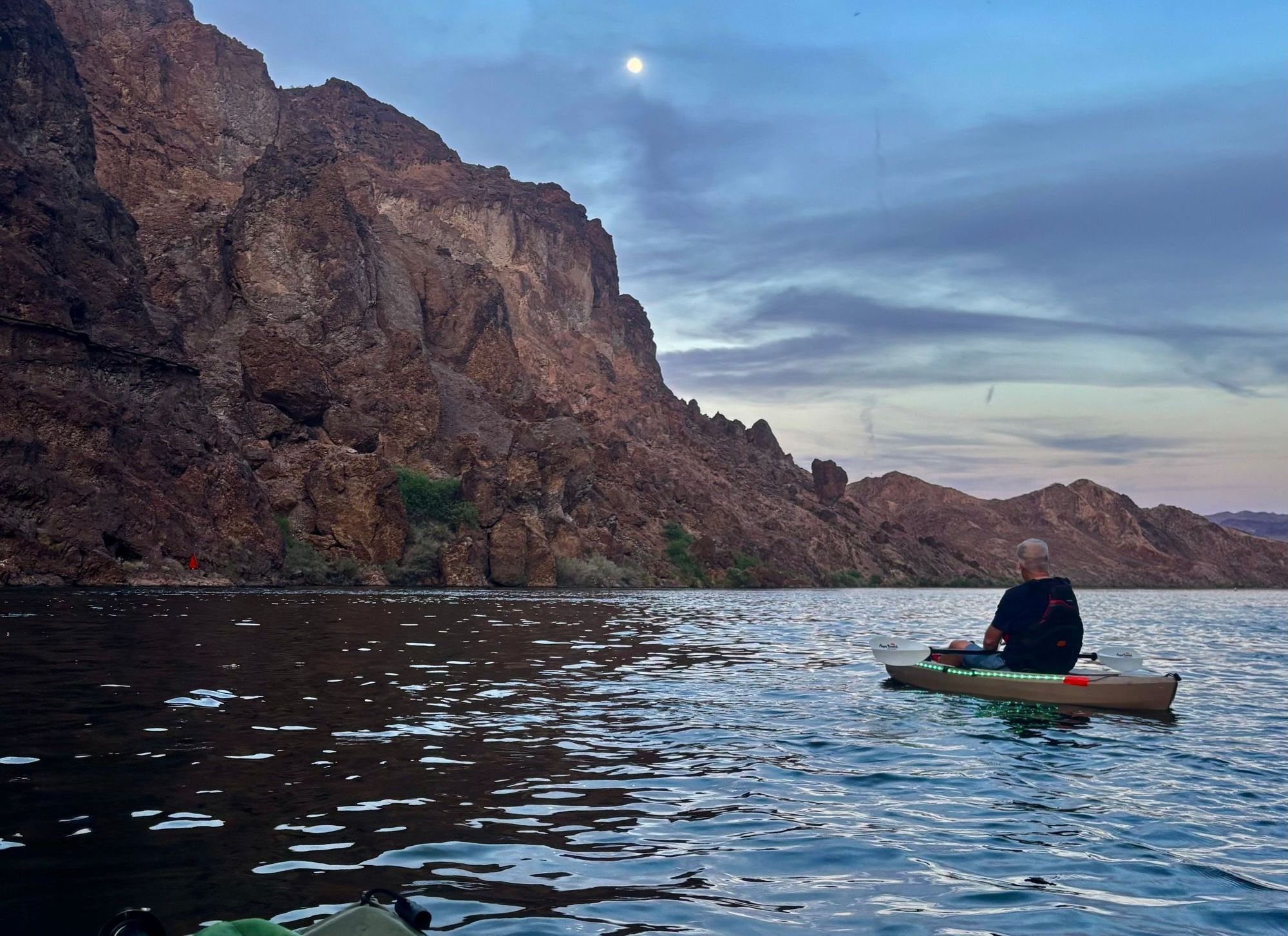Guest enjoy a view of the full moon by kayak on Lake Mead.