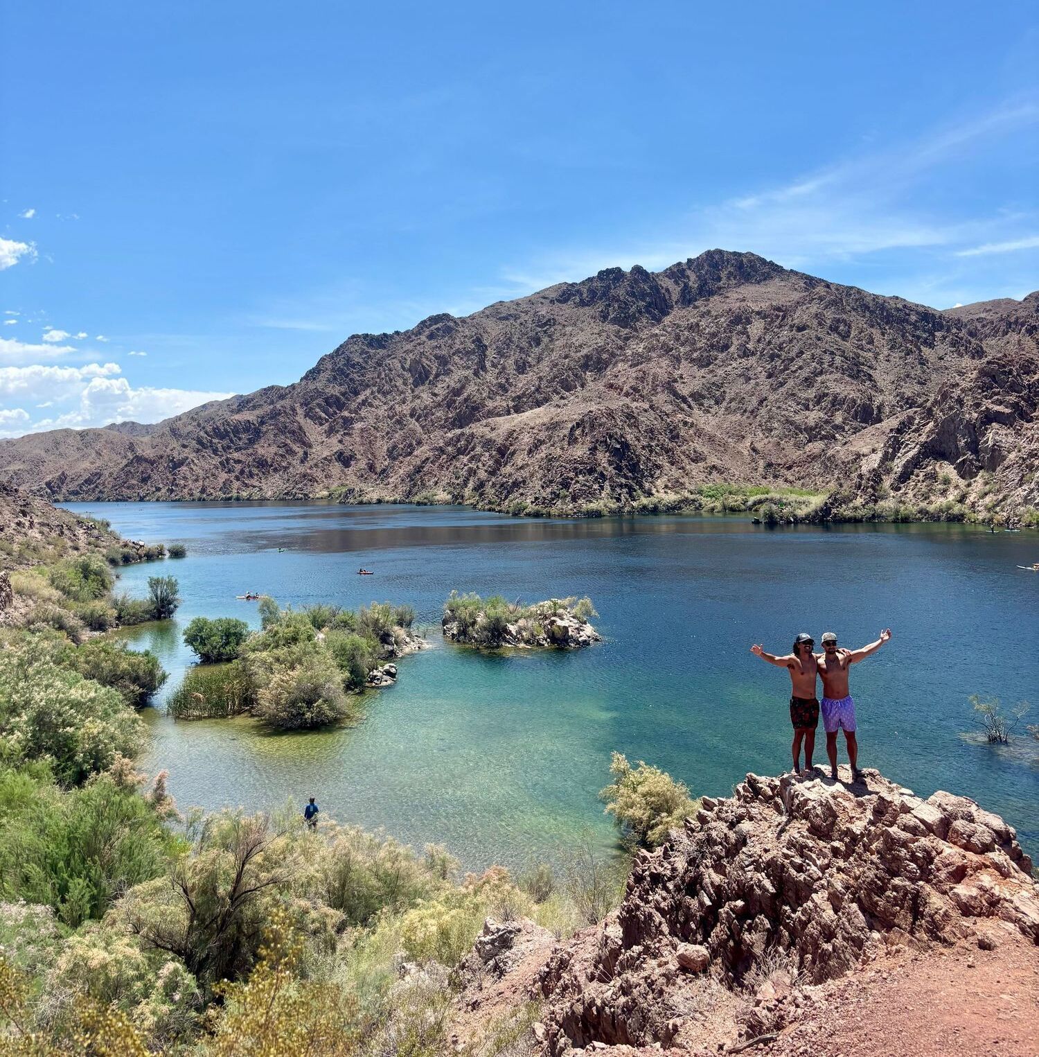 Guests on a kayak tour take a moment to pose at a scenic vista above the Colorado River