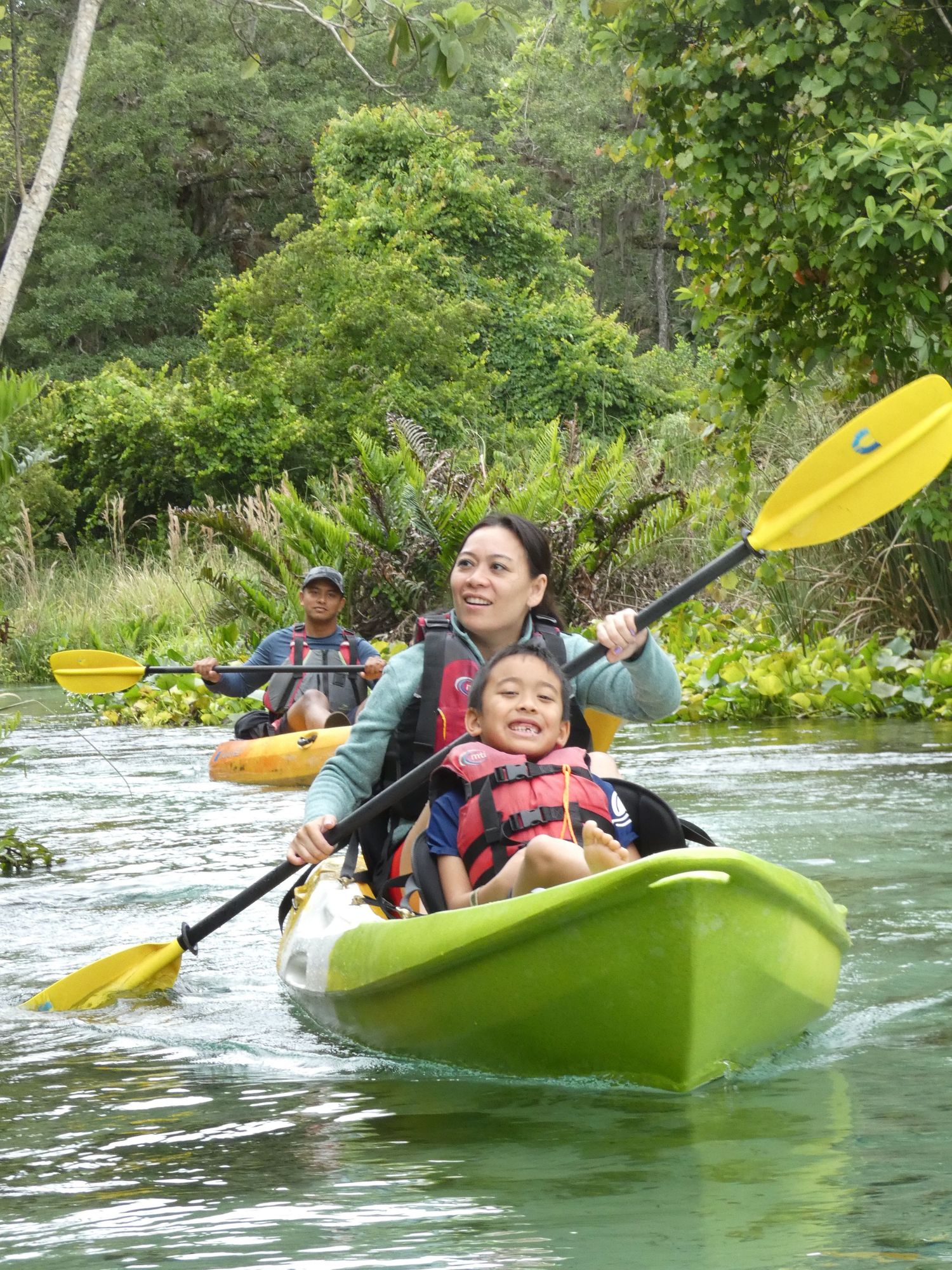 Family enjoying a peaceful kayak tour along the crystal clear waters.