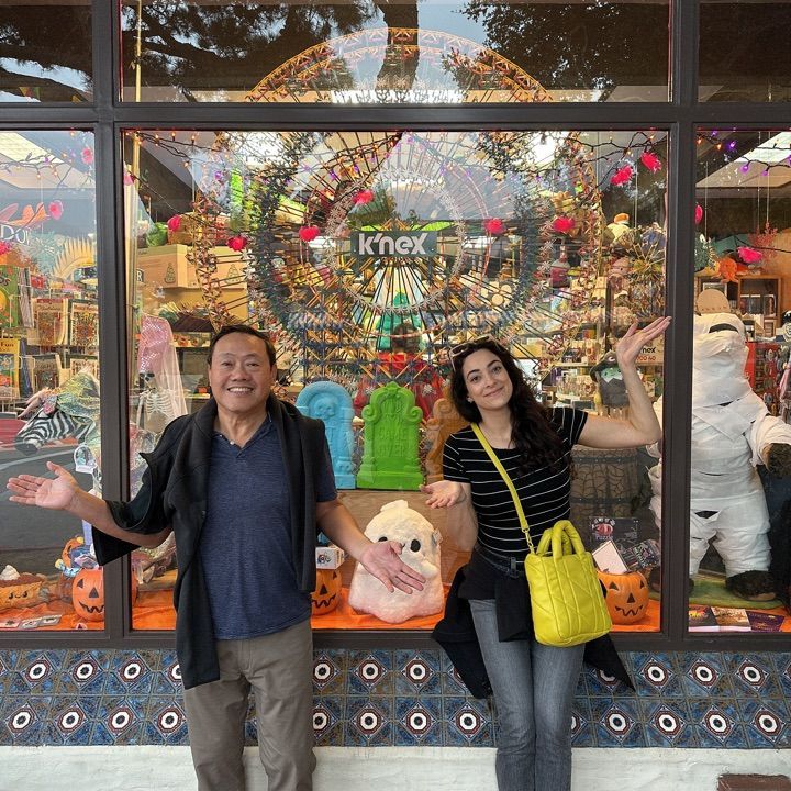 A man and a woman standing in front of a shop window in Carmel by the Sea
