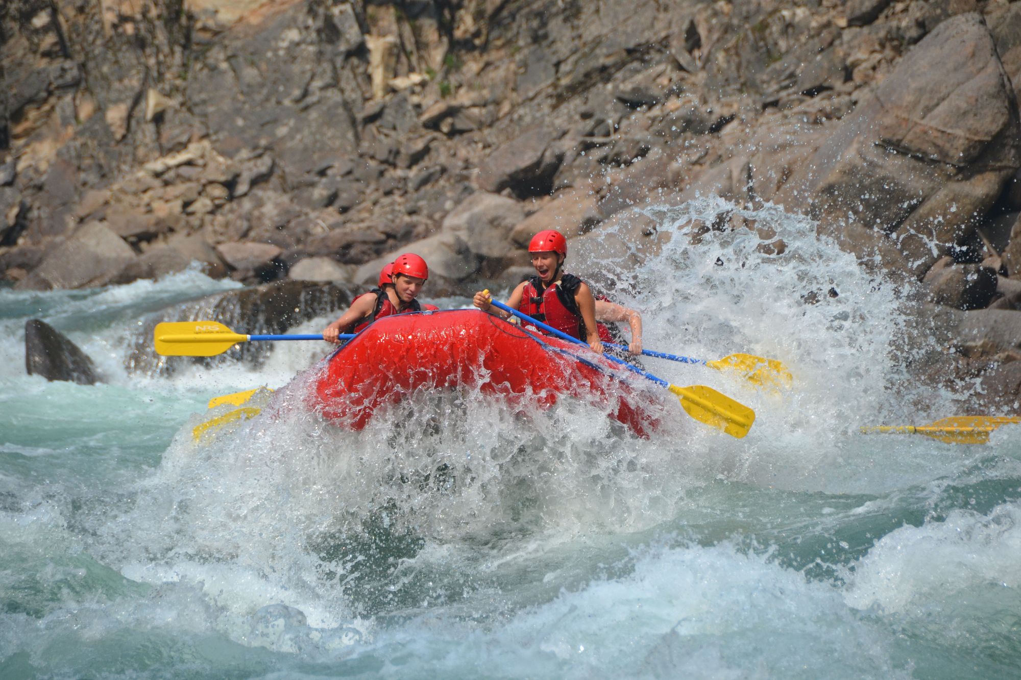 whitewater rafting sown the Clearwater River. Splashing over a big wave!