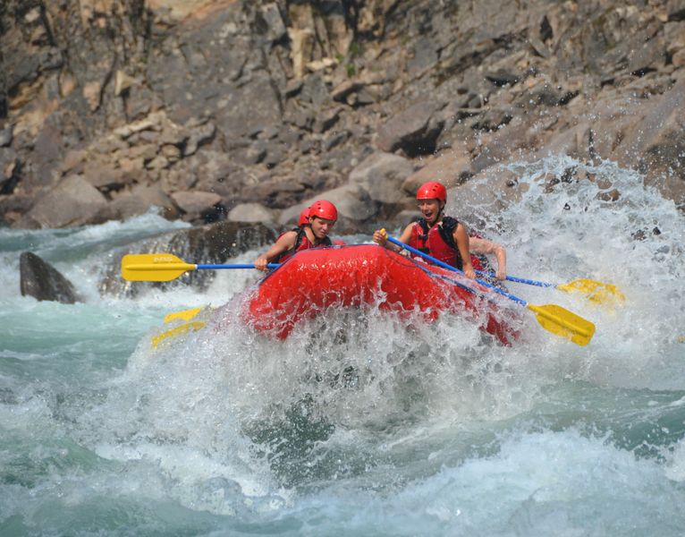 whitewater rafting sown the Clearwater River. Splashing over a big wave!
