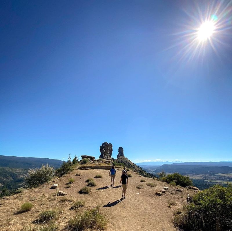 Image from @alongforthetrip from visitpagossprings.com of the summit of Chimney Rock West of Pagosa Springs