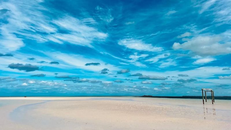 Eleuthera beach with turquoise water, sand, and vivid sky. 