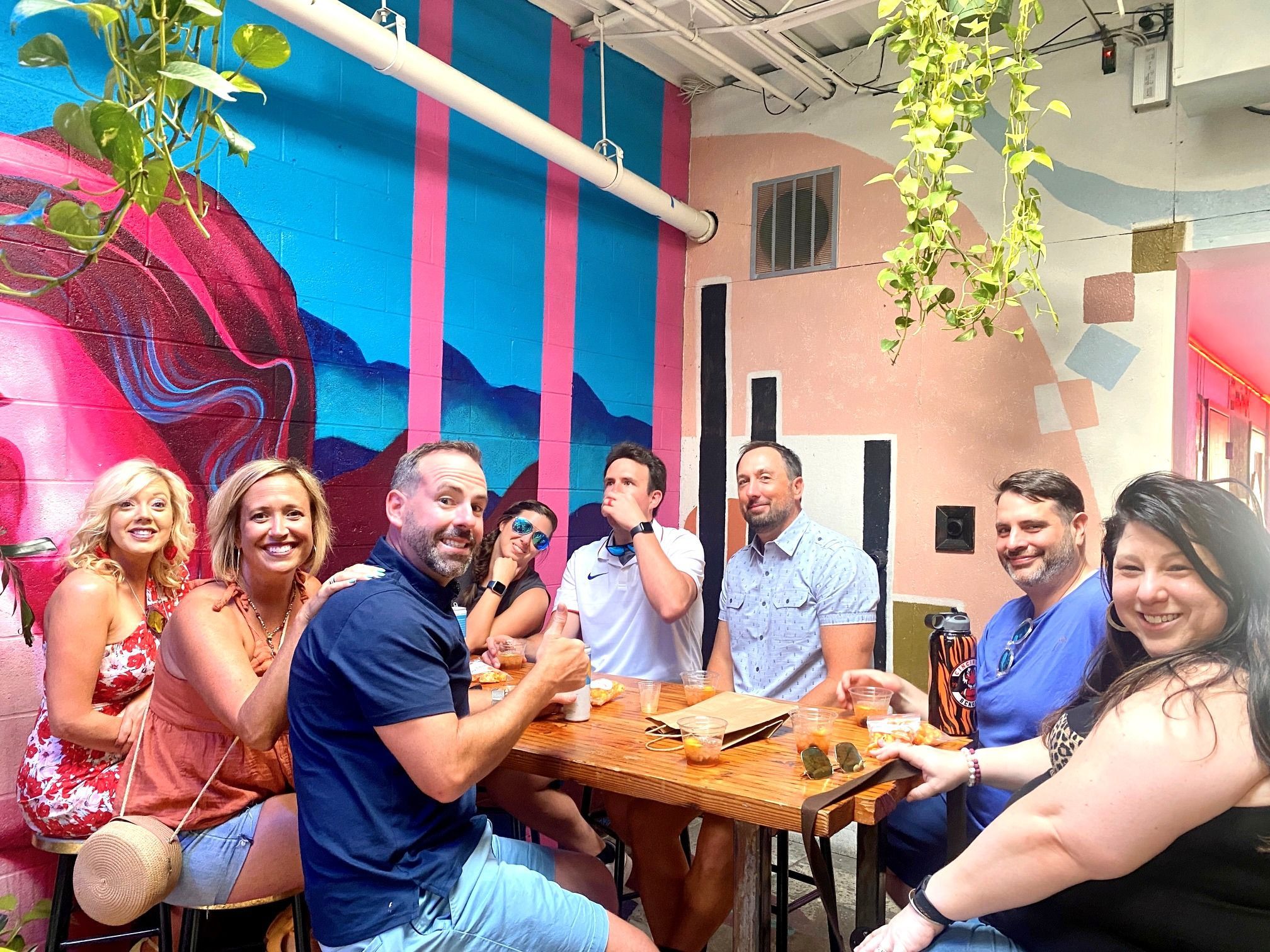 A group of friends smiling and enjoying cocktails on Riverside Food Tours in Cincinnati Ohio: Over-the-Rhine Cocktail Tour