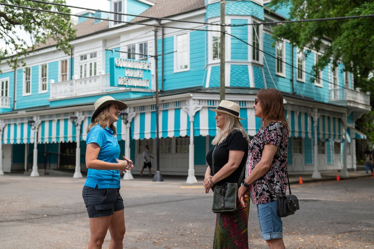 Tour guide explaining the significance of Commander's Palace on the Garden District tour.