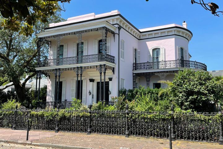 Pink, 8,000-sq-ft mansion with Italianate features such as lacy iron work.