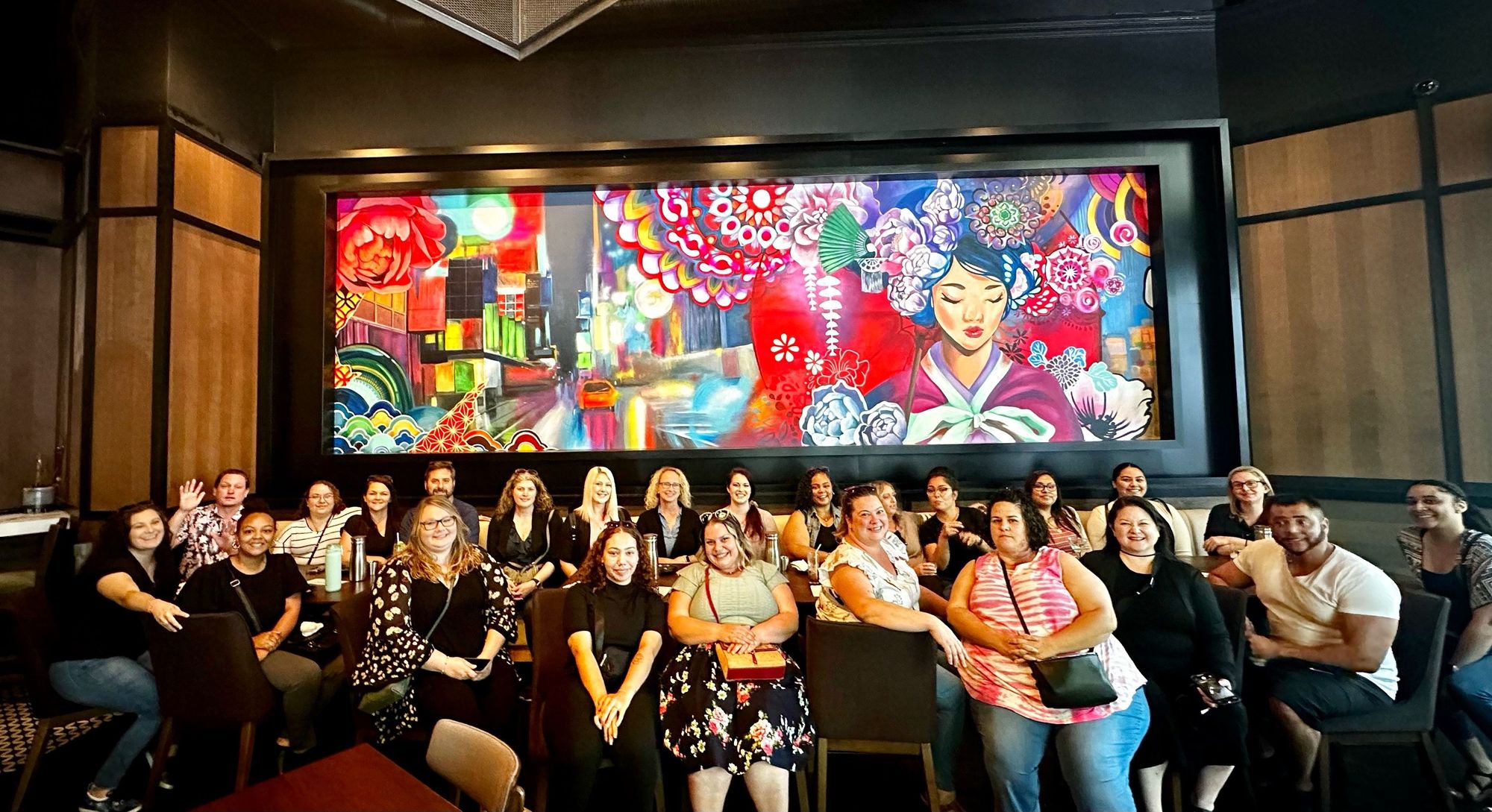 group in front of mural