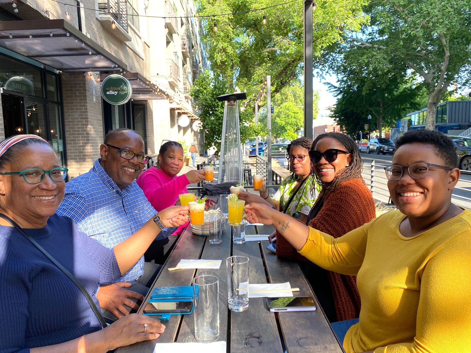 family smiling and raising glasses