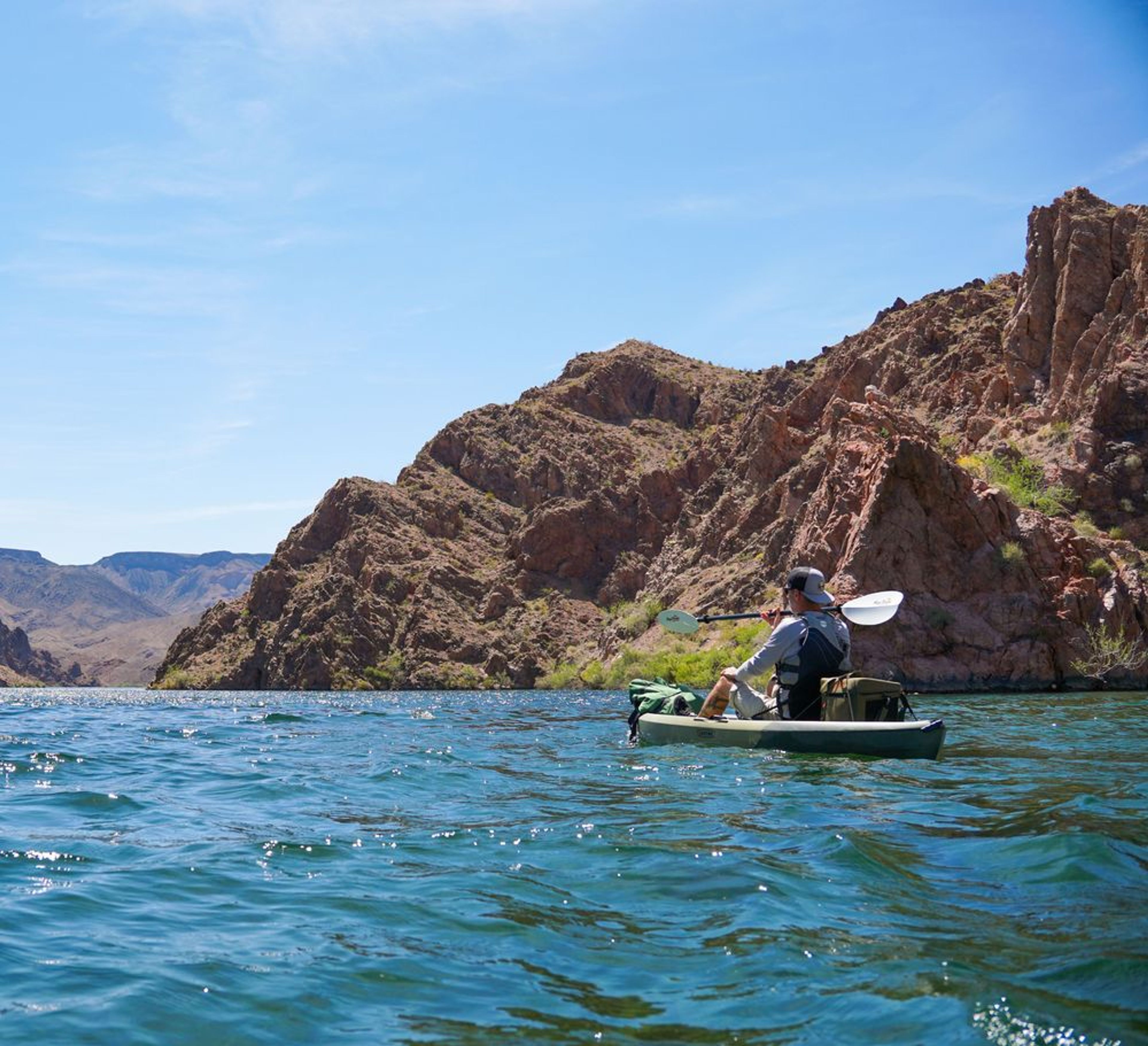 Kayaker paddling at a secluded bend on the Colorado River during a full-day black canyon narrows tour.