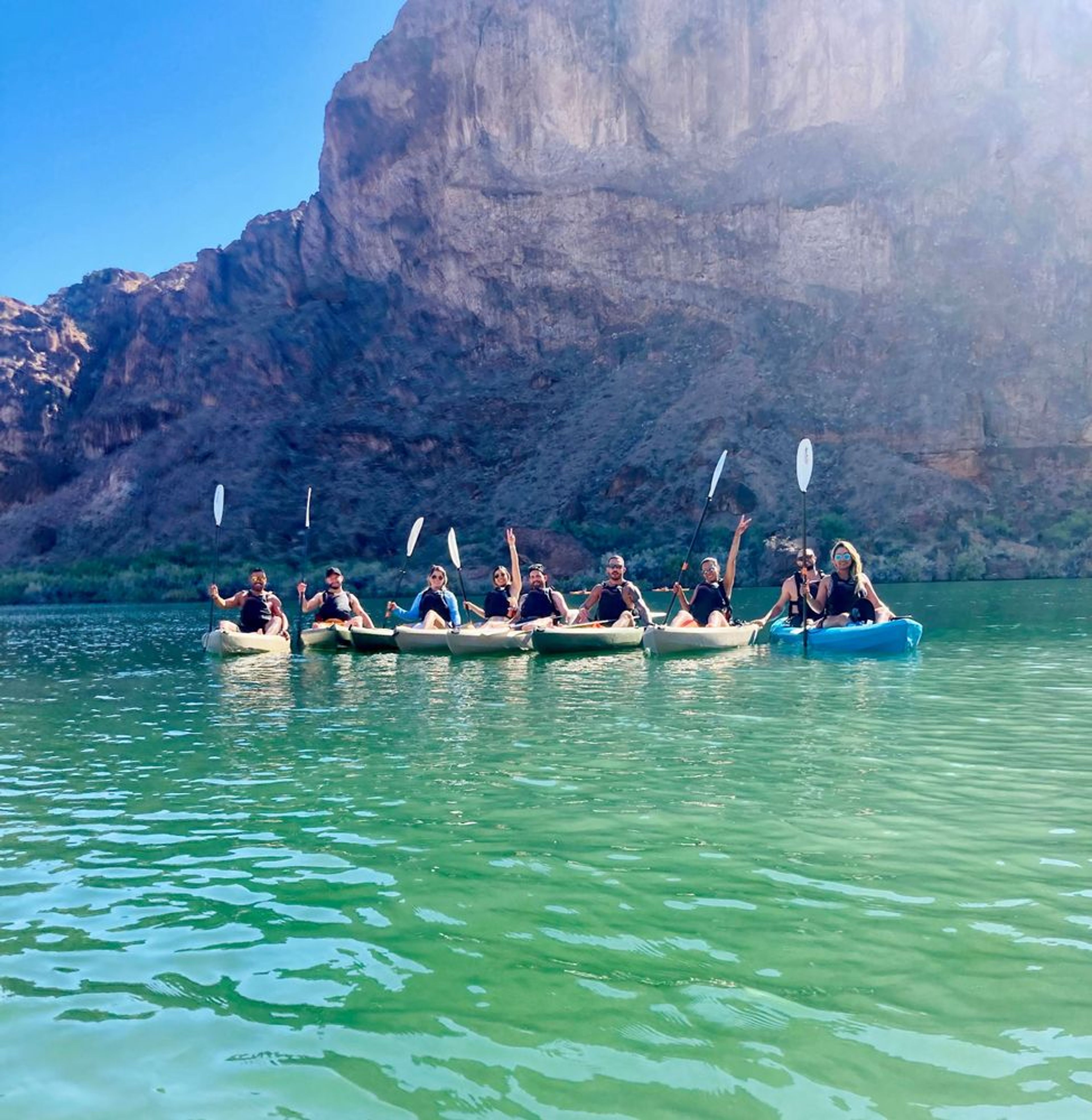 Guests smiling after kayaking to Emerald Cave on a guided kayaking tour