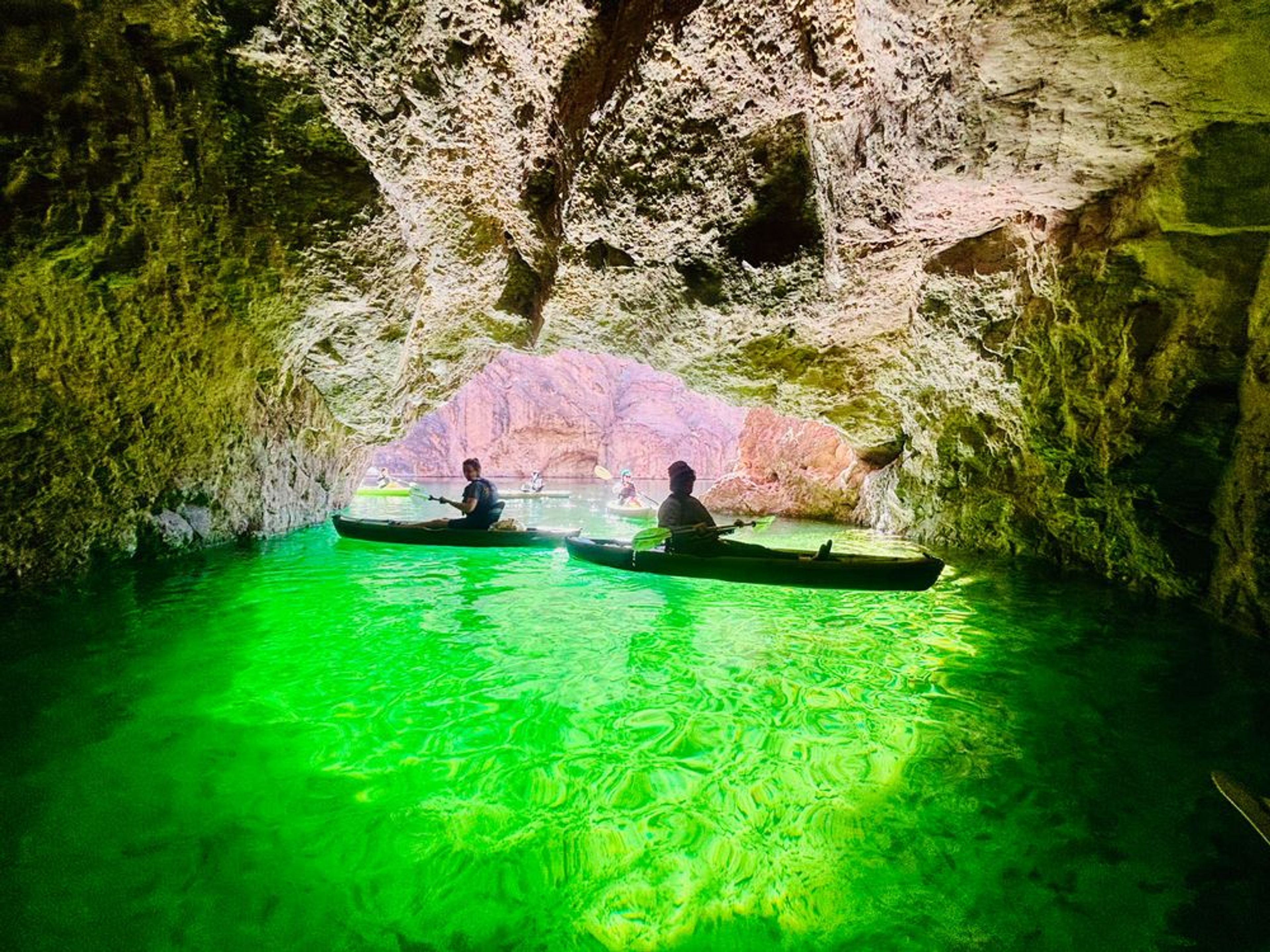 Kayakers paddling into the glowing Emerald Cave in Black Canyon near Las Vegas