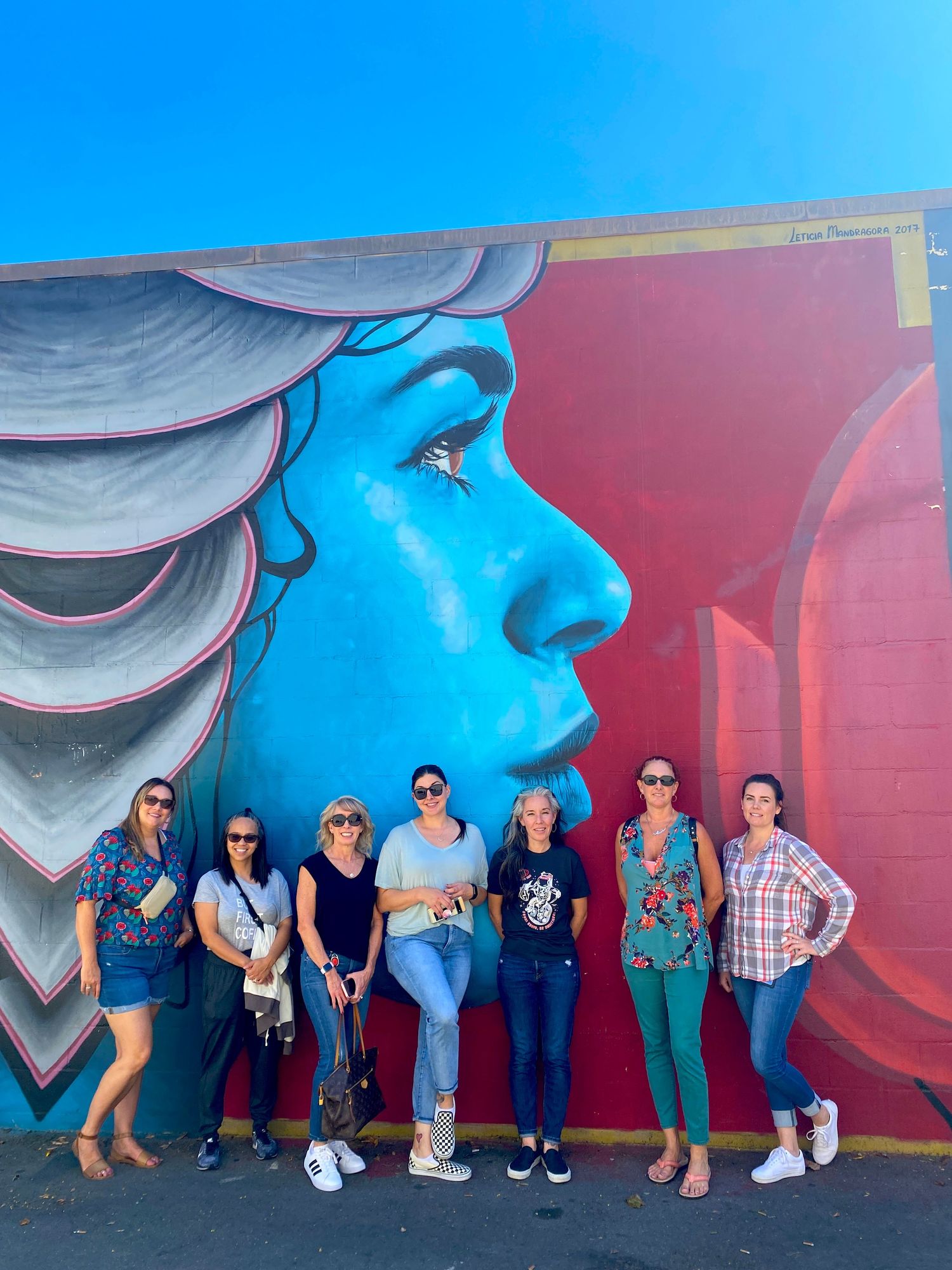 people in front of mural