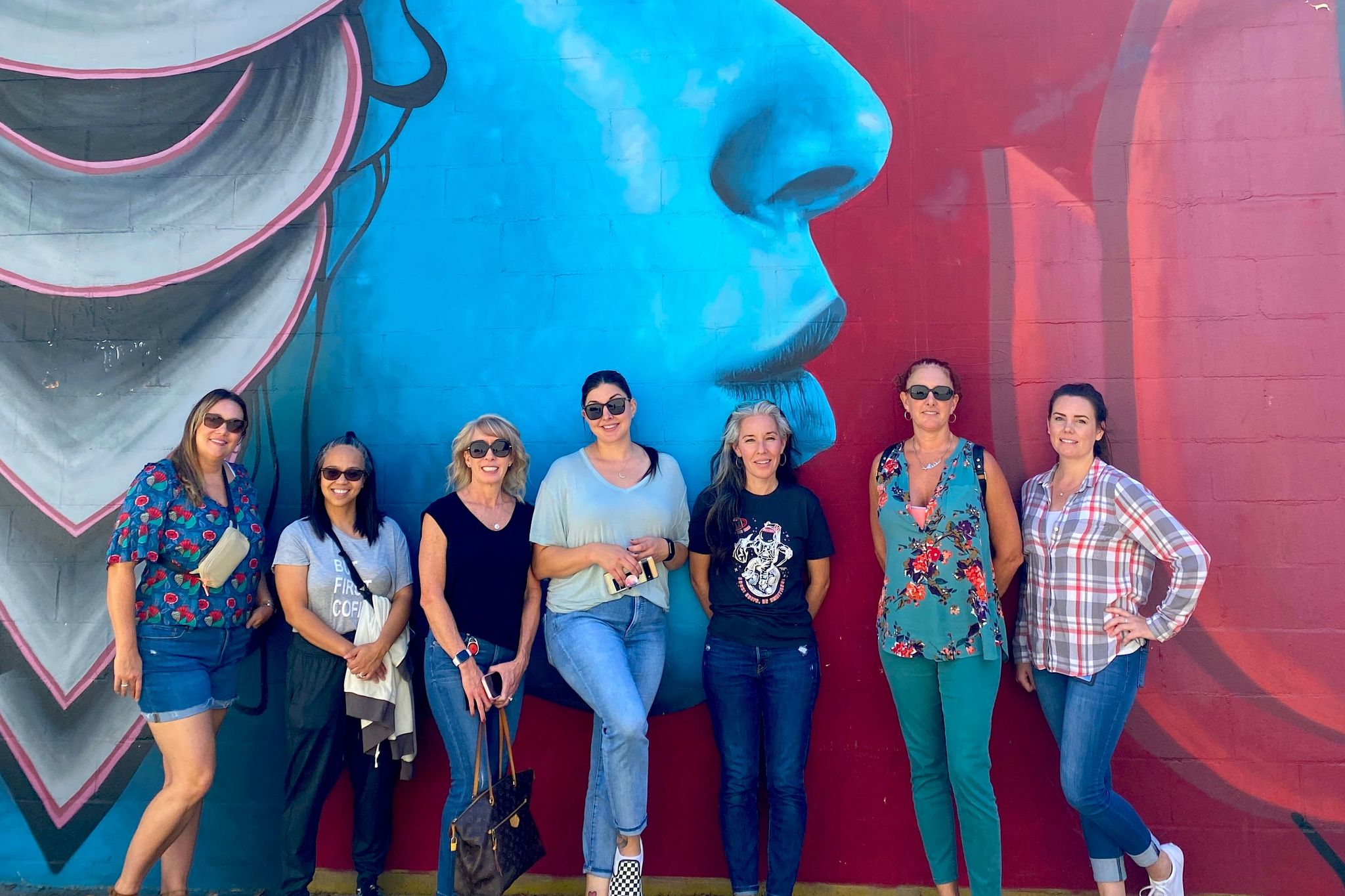 people in front of mural