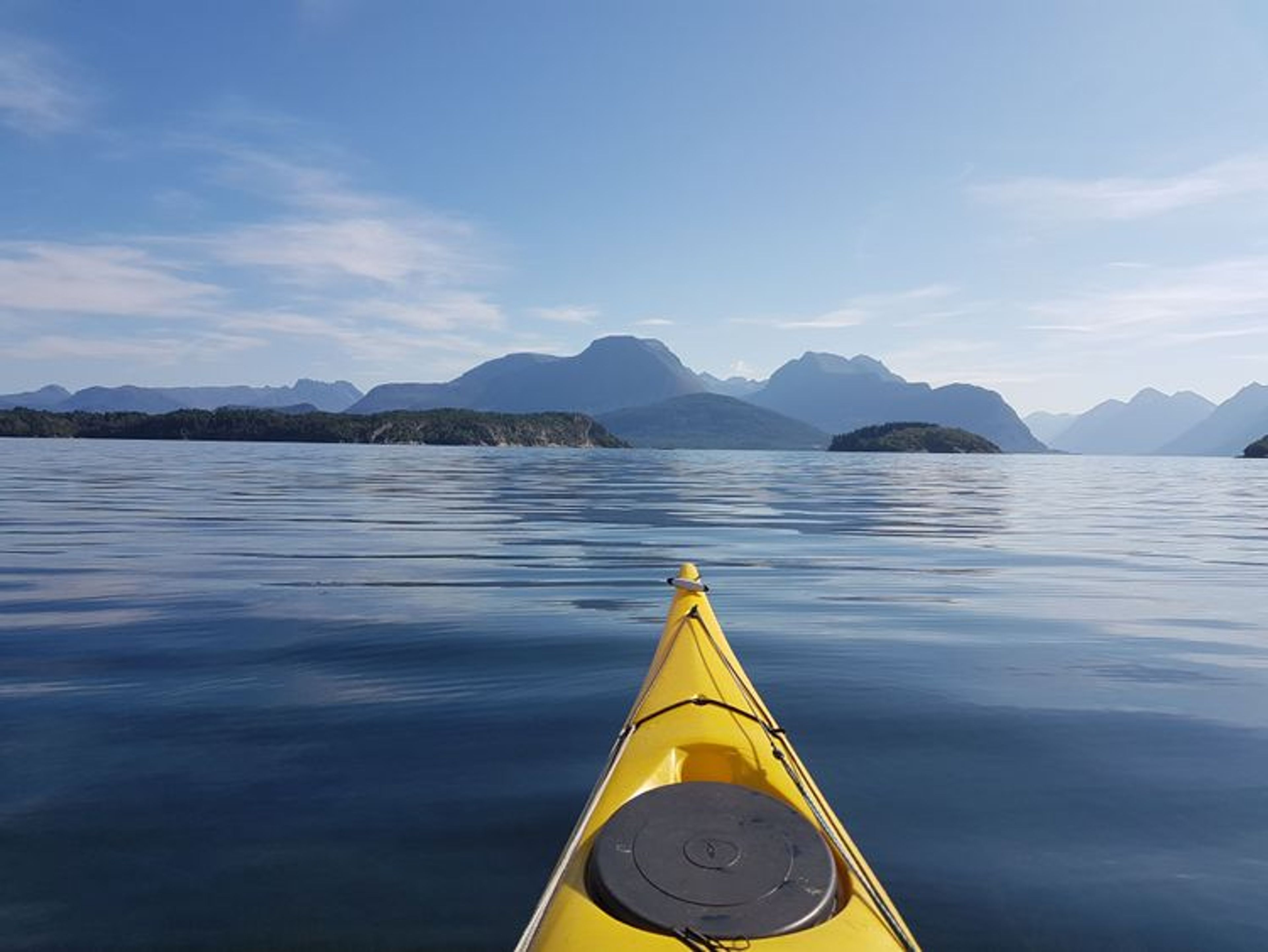 Our sea kayaks as we glide out onto the glistening fjord waters 