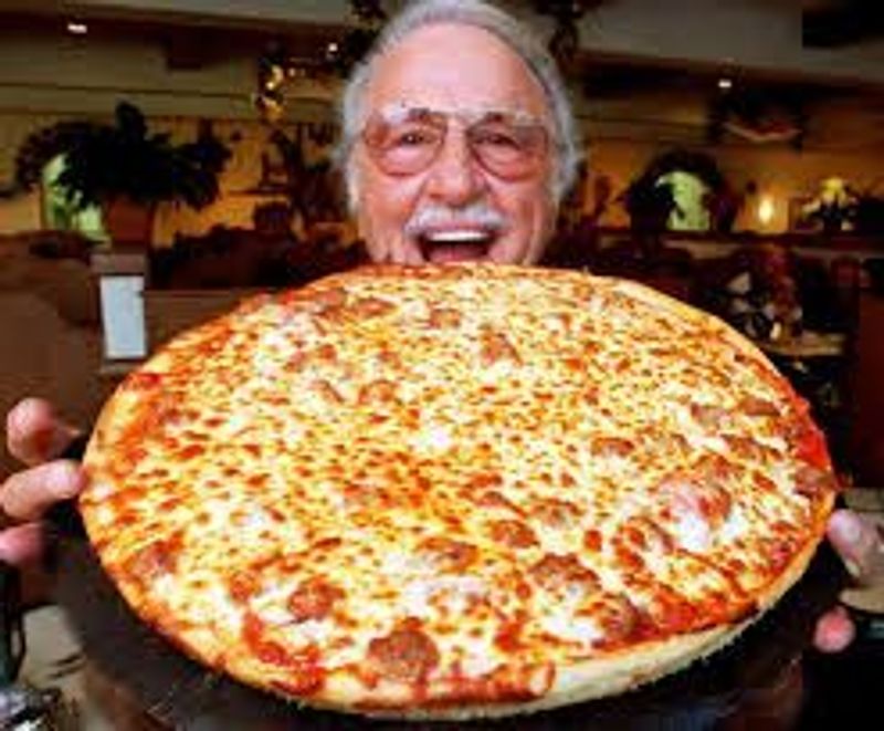 a man holding a slice of pizza