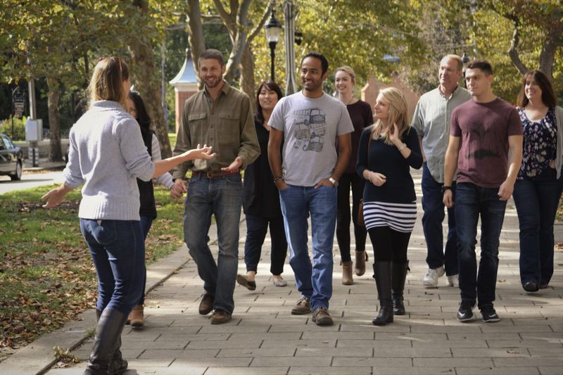 a group of people standing on a sidewalk