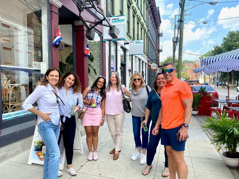 a group of people standing on a sidewalk