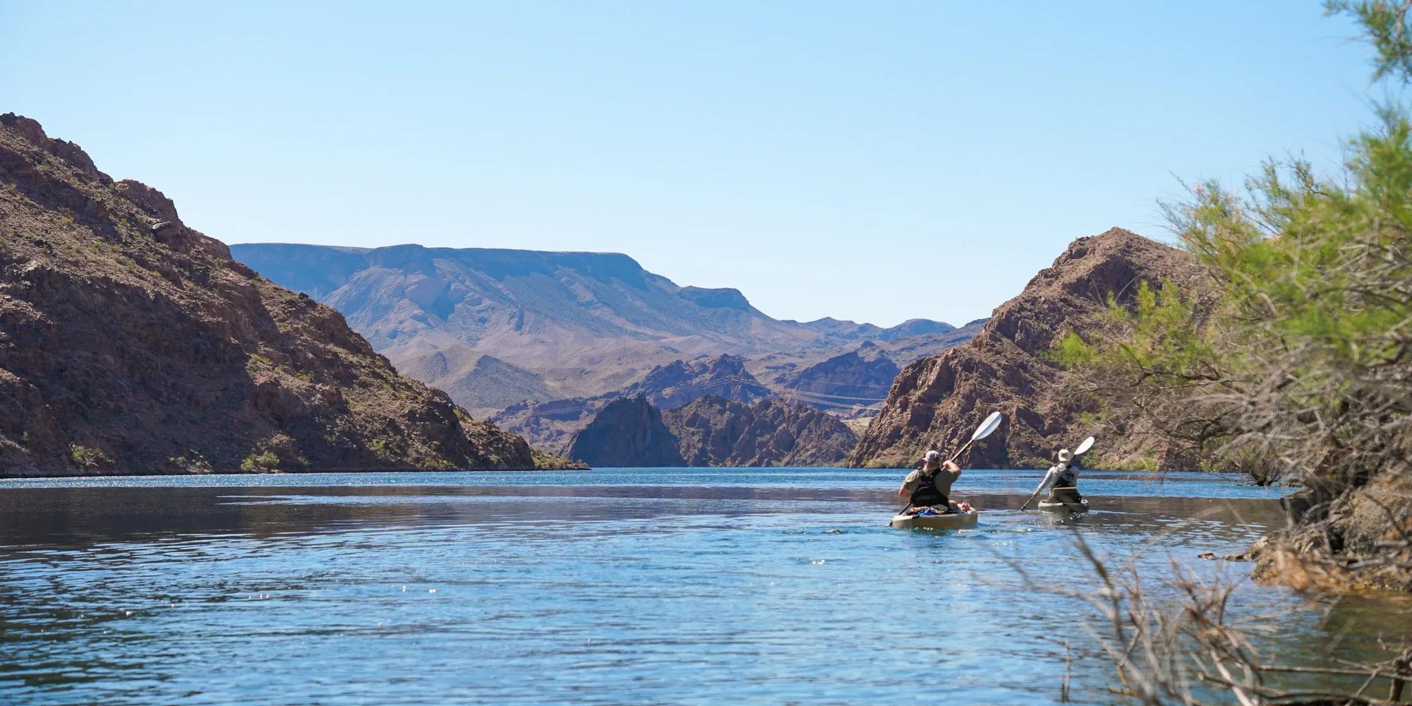 Peaceful stretch of the Colorado River winding through the rugged canyon walls during a kayak tour near Las Vegas