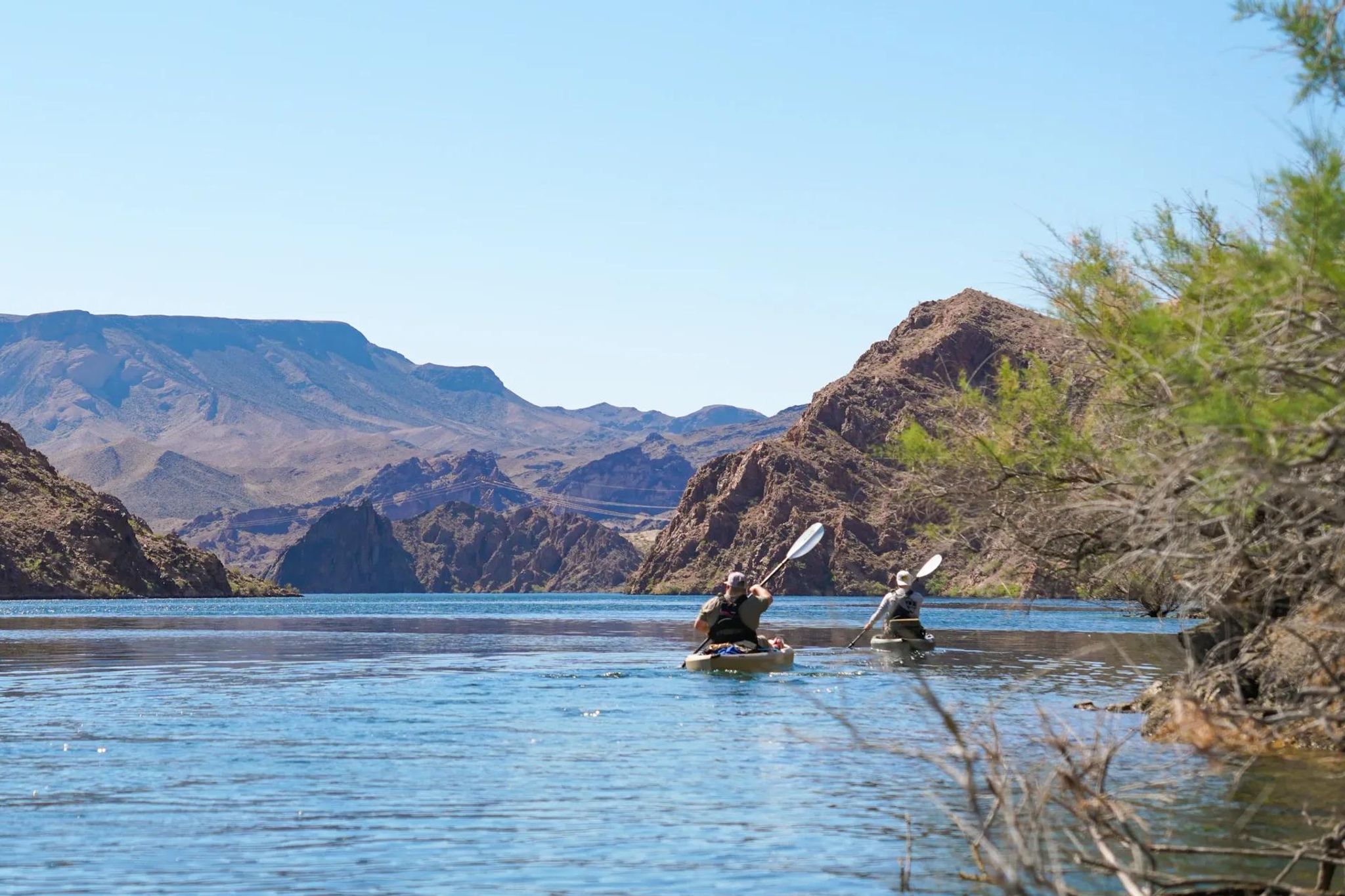 Peaceful stretch of the Colorado River winding through the rugged canyon walls during a kayak tour near Las Vegas