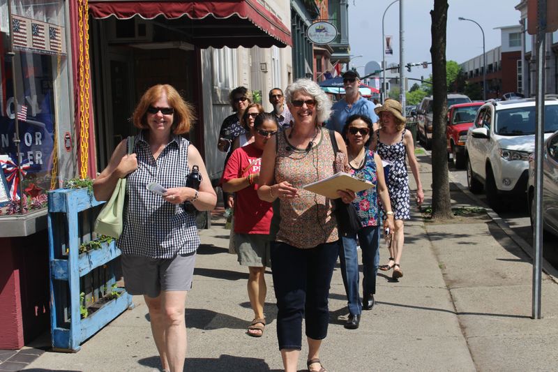 a group of people standing on a sidewalk