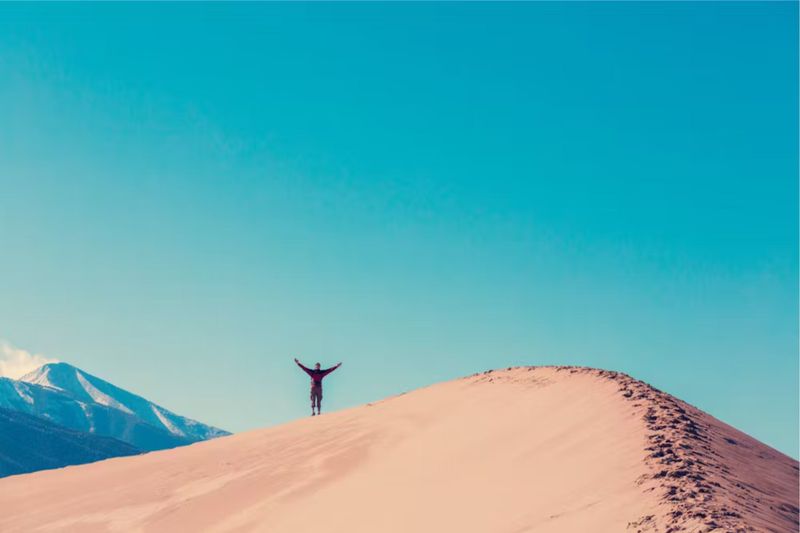 person standing atop the Great Sand Dunes in Colorado