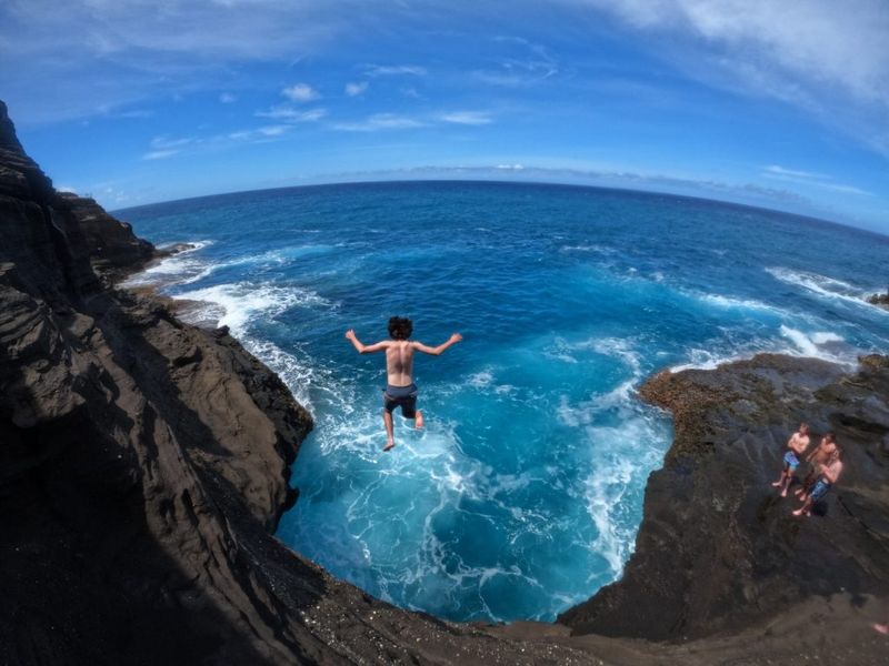 a man riding a wave on top of a mountain