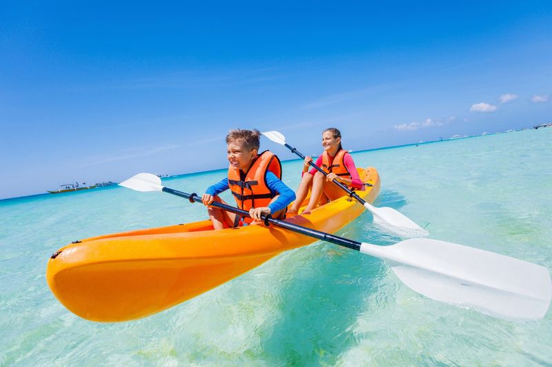 Kayaking At Seven Mile Beach With Kids In The Turquoise Waters