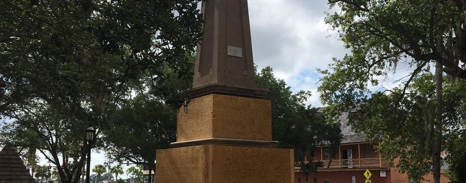 a statue in front of a building